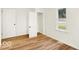 Cozy bedroom featuring wood-look floors, white walls and trim, and closet space at 701 E Memorial Dr, Muncie, IN 47302