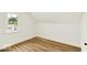 A clean room showcasing natural light and new wood flooring at 701 E Memorial Dr, Muncie, IN 47302
