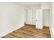 A brightly lit bedroom with laminate floors, closet, and white trim at 701 E Memorial Dr, Muncie, IN 47302