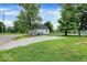 Home exterior showing a nice yard space, gravel parking pad, and proximity to the street at 701 E Memorial Dr, Muncie, IN 47302