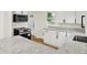 Modern kitchen features white cabinets, black appliances, granite counters, and wood-look flooring at 701 E Memorial Dr, Muncie, IN 47302