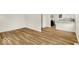 Spacious living area flowing to the kitchen shows modern flooring, fresh paint, and open layout at 701 E Memorial Dr, Muncie, IN 47302