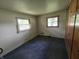 Bedroom with carpet, multiple windows for natural light, and built-in storage units at 7088 Sandalwood Dr, Indianapolis, IN 46217