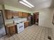 Functional kitchen includes ample cabinet space, a gas range, and a refrigerator at 7088 Sandalwood Dr, Indianapolis, IN 46217