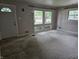 Bright living room featuring a large picture window and neutral-toned carpet at 7088 Sandalwood Dr, Indianapolis, IN 46217