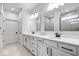 Bright bathroom featuring a double vanity with white countertops, modern fixtures, and ample cabinet space at 7154 Covington St, Lebanon, IN 46052