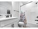 Clean bathroom showcases modern fixtures, a shower with a floral curtain, and sleek hardware at 7154 Covington St, Lebanon, IN 46052
