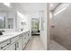 Modern bathroom with double vanity, sleek fixtures, and tiled shower with glass enclosure, offering a spa-like experience at 7154 Covington St, Lebanon, IN 46052