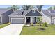 Charming single-Gathering home featuring a gray color scheme, well-manicured lawn, and attached garage at 7154 Covington St, Lebanon, IN 46052
