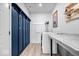 Modern laundry room featuring a front load washer, counter space, and ample storage at 7154 Covington St, Lebanon, IN 46052