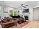 Cozy living room featuring hard wood floors, neutral walls, fireplace, and plenty of natural light at 7154 Covington St, Lebanon, IN 46052