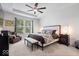 Serene main bedroom retreat featuring a tray ceiling, large window, and plush furnishings at 7154 Covington St, Lebanon, IN 46052