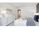 Well-lit bedroom with a full-size dresser and a doorway to the bathroom at 7177 Firestone Rd, Whitestown, IN 46052