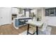 A view of a kitchen and dining area with stainless steel appliances, wooden floors, and modern decor at 7177 Firestone Rd, Whitestown, IN 46052