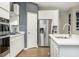White cabinets, stainless steel appliances, and quartz countertops in a modern kitchen space at 7177 Firestone Rd, Whitestown, IN 46052
