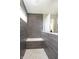 Luxurious tiled shower with a built-in seat and modern fixtures at 7177 Firestone Rd, Whitestown, IN 46052