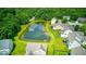 Aerial view of a pond within a residential neighborhood, surrounded by lush trees at 7212 Maple Bluff Pl, Indianapolis, IN 46236