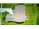 Aerial shot of a home with a deck featuring outdoor seating and views of the landscaped yard and nearby pond at 7212 Maple Bluff Pl, Indianapolis, IN 46236