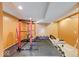 This is an image of a basement gym with weight training equipment, black flooring, and painted walls at 7212 Maple Bluff Pl, Indianapolis, IN 46236