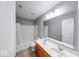 Bright bathroom with a double sink vanity and a shower-tub combo at 7212 Maple Bluff Pl, Indianapolis, IN 46236