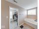 Bright bathroom featuring a bathtub and a walk-in closet at 7212 Maple Bluff Pl, Indianapolis, IN 46236