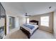 Comfortable bedroom with a ceiling fan, natural light, and a calm color palette at 7212 Maple Bluff Pl, Indianapolis, IN 46236