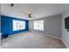 Bright bedroom featuring neutral carpeting and a blue accent wall at 7212 Maple Bluff Pl, Indianapolis, IN 46236