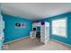 Bedroom with blue walls, built-in desk, shelves, and ample natural light at 7212 Maple Bluff Pl, Indianapolis, IN 46236
