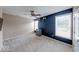 A lovely room that features two windows and a dark accent wall with hats hanging on the wall at 7212 Maple Bluff Pl, Indianapolis, IN 46236