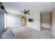 Bedroom featuring carpet, TV on the wall, ceiling fan, double door closet, and an entrance into another room at 7212 Maple Bluff Pl, Indianapolis, IN 46236