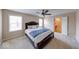 Cozy carpeted bedroom featuring a ceiling fan and ensuite bathroom at 7212 Maple Bluff Pl, Indianapolis, IN 46236