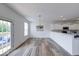 Bright dining area featuring modern flooring and pendant lighting next to the kitchen at 7212 Maple Bluff Pl, Indianapolis, IN 46236