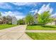 Brick home featuring a long driveway, an attached garage and mature trees in a lovely landscaped yard at 7212 Maple Bluff Pl, Indianapolis, IN 46236