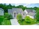 Beautiful two-story brick home featuring a manicured lawn and a welcoming blue entryway at 7212 Maple Bluff Pl, Indianapolis, IN 46236