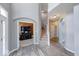 Welcoming foyer with a grand staircase and an arched doorway leading to the office space at 7212 Maple Bluff Pl, Indianapolis, IN 46236