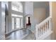 Bright foyer with stylish floors, large windows, and a staircase leading upstairs at 7212 Maple Bluff Pl, Indianapolis, IN 46236