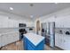 Stylish kitchen featuring white cabinetry, stainless appliances, a center island with quartz countertop, and hardwood floors at 7212 Maple Bluff Pl, Indianapolis, IN 46236