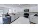 Bright kitchen with white cabinets, stainless steel appliances, blue island and modern countertops at 7212 Maple Bluff Pl, Indianapolis, IN 46236
