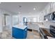 Bright kitchen with white cabinets, stainless steel appliances, blue island and modern countertops at 7212 Maple Bluff Pl, Indianapolis, IN 46236