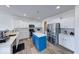 Bright, modern kitchen with white cabinets, a stainless steel fridge, and a blue central island at 7212 Maple Bluff Pl, Indianapolis, IN 46236