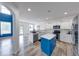 Bright kitchen with white cabinets, stainless steel appliances, blue island and modern countertops at 7212 Maple Bluff Pl, Indianapolis, IN 46236