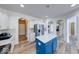 Bright kitchen with white cabinets, stainless steel appliances, blue island and modern countertops at 7212 Maple Bluff Pl, Indianapolis, IN 46236