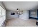 Spacious living room featuring neutral walls, plush carpeting, and a ceiling fan at 7212 Maple Bluff Pl, Indianapolis, IN 46236