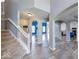 Lovely open concept living room with arches, a staircase, and views of other rooms at 7212 Maple Bluff Pl, Indianapolis, IN 46236