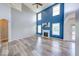 Bright living room with fireplace, tall ceilings, arches, and access to outdoor areas at 7212 Maple Bluff Pl, Indianapolis, IN 46236