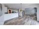 Open-concept living space featuring modern flooring, arched doorways, and a view into the bright kitchen at 7212 Maple Bluff Pl, Indianapolis, IN 46236