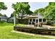 Lush backyard with patio, dining table, and beautiful landscaping creating a serene outdoor space at 7242 Highburry Dr, Indianapolis, IN 46256