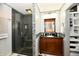 Bathroom featuring a glass shower, cherry vanity with dark countertop and decorative tile backsplash at 7242 Highburry Dr, Indianapolis, IN 46256