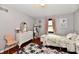 Cozy bedroom showcasing light gray walls, a white dresser, and a charming accent rug at 7242 Highburry Dr, Indianapolis, IN 46256