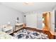 Stylish bedroom with white closet doors, a patterned rug, and a modern desk at 7242 Highburry Dr, Indianapolis, IN 46256